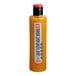 A close up of a SHOTT Turmeric, Lemon, Ginger, and Honey syrup bottle with a red lid.