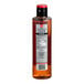 A bottle of SHOTT Hazelnut flavoring syrup on a counter with a red cap and label.