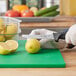 A person cutting a lemon with a Choice serrated edge knife.