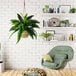 A 30" artificial Boston fern in a 2-tone natural hanging basket in a room with a green chair and plant.