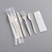 A plastic bag of Choice beige heavy weight wrapped plastic cutlery with a napkin, including a spoon and fork.