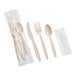 A beige heavy weight plastic cutlery pack with a knife, fork, spoon, and napkin, individually wrapped.