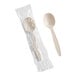A beige heavy weight polystyrene plastic soup spoon, with one spoon individually wrapped in plastic and one unwrapped.