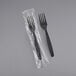 Two black heavy weight plastic forks in plastic packaging.