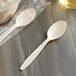 A plastic wrapped Choice beige plastic spoon.