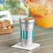 A Ball aluminum cup with the Everyday logo being filled with orange juice.