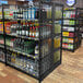 A Wanzl single-sided gondola shelving unit with liquor on the shelves.