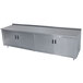 A stainless steel Advance Tabco enclosed base work table with a fixed midshelf.