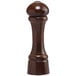 A close-up of a wooden Chef Specialties Windsor walnut salt or pepper shaker with a black knob.