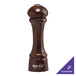 A wooden salt or pepper shaker with a walnut finish.