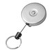 A close-up of a silver metal KEY-BAK keychain with a key on it.