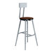 A National Public Seating lab stool with a steel frame and Montana walnut wood seat and backrest.