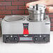 A woman using a Vollrath countertop rethermalizer to cook food.