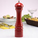 A Chef Specialties candy apple red pepper mill on a table.