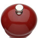 A Chef Specialties red pepper mill with a silver top.