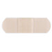 A close up of a white square Medique adhesive bandage strip package.