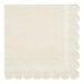 A white napkin with scalloped edges.