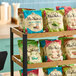 A display rack filled with assorted bags of Miss Vickie's kettle cooked potato chips in various flavors.