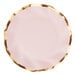 A close-up of a Sophistiplate pink and gold wavy paper salad plate.