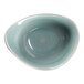 A close-up of a RAK Porcelain white bowl with a blue rim.