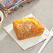 A piece of Ne-Mo's Bakery Streusel Coffee Cake on a napkin next to a cup of coffee.