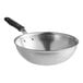 A Vollrath stainless steel stir fry pan with a black silicone handle.