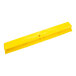 A yellow Carlisle Sparta push broom head with bristles.