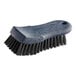 A close-up of a Carlisle Sparta black handheld scrub brush with black bristles.