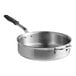 A Vollrath stainless steel saute pan with a black silicone handle and lid.