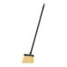 A Carlisle yellow flagged angled lobby broom with a black handle and yellow bristles.