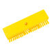 A yellow brush with bristles and a hole in the center.