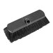 A close-up of a Carlisle black deck brush with a handle.