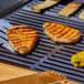 Eat Meati plant-based Classic Cutlets cooking on a grill.