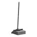 A black Carlisle dustpan with a long black pole.