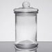 A clear glass Libbey bell jar with a black lid on a table.
