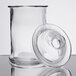 A Libbey clear glass bell jar with a lid on a table.