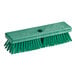 A Carlisle Sparta green deck brush with a hole in the handle.