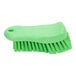 A close-up of a Carlisle lime green handheld scrub brush with bristles.