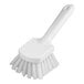 A close-up of a Carlisle white pot scrub brush with a handle.