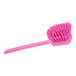 A Carlisle Sparta pink pot scrub brush with a long handle and bristles.