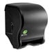 A black San Jamar Tear-N-Dry Essence EcoLogic roll towel dispenser on a counter.