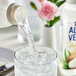 A close-up of a Goya Coconut Aloe Vera Drink bottle with a white label and black stripe.