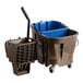 A brown Carlisle OmniFit mop bucket on wheels with a blue wringer handle.