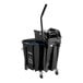 A black Carlisle OmniFit mop bucket with wringer on wheels.