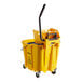 A yellow Carlisle OmniFit mop bucket with a black handle.