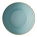 A close-up of a Oneida Moira frosted blue stoneware bowl with a white rim.