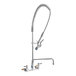 A T&S stainless steel wall-mounted pre-rinse faucet with a hose.