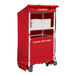 A red Royal Basket Trucks laundry cart with towels on it.