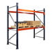 A blue and orange Interlake Mecalux heavy-duty pallet rack with boxes on the shelves.