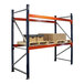 A blue and orange Interlake Mecalux heavy-duty metal pallet rack with boxes on it.